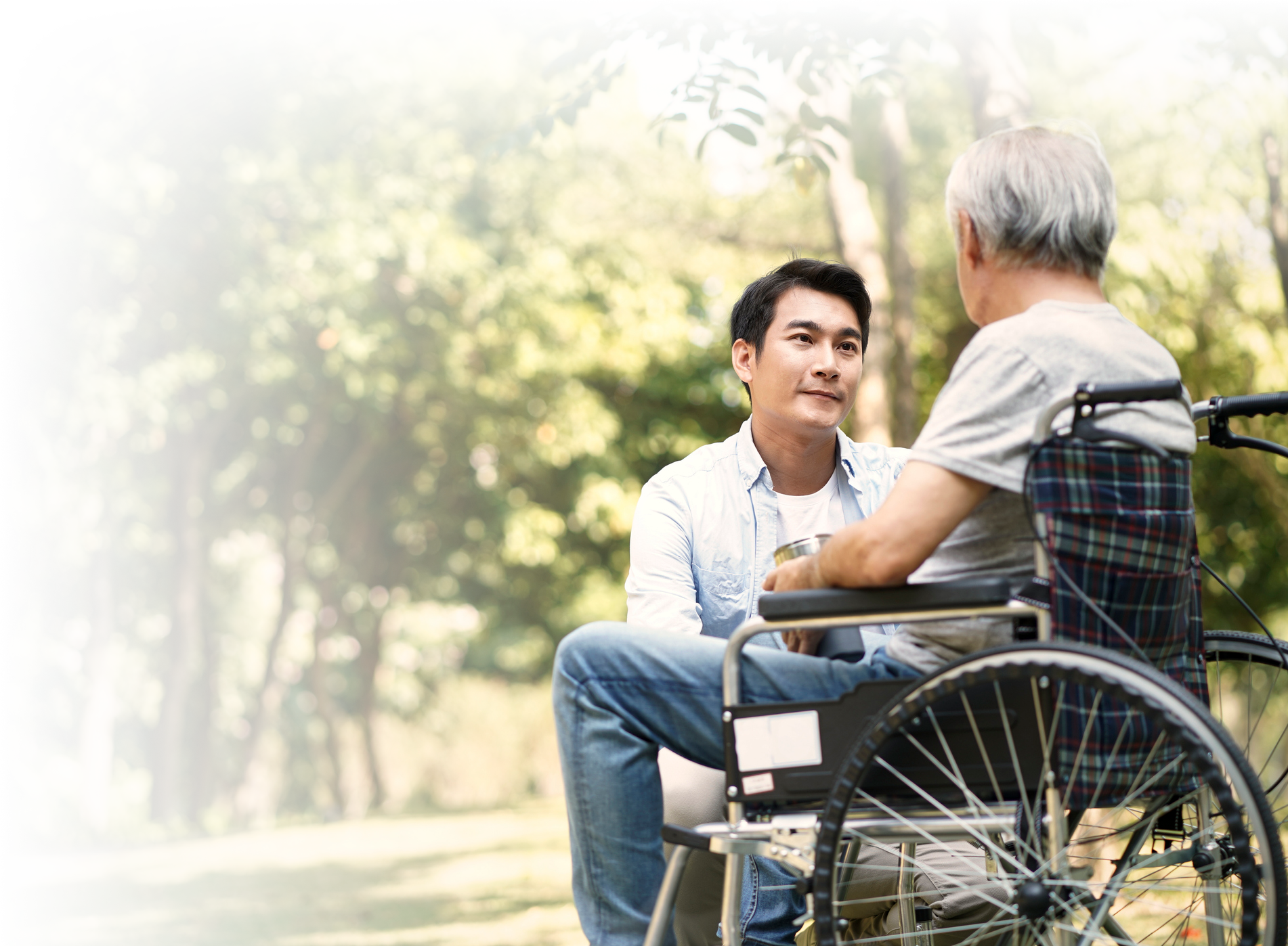 Photo of a young man conversating with a senior.