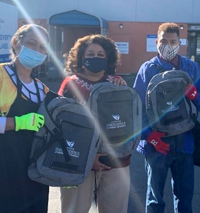 Photo of people together with their emergency backpacks.