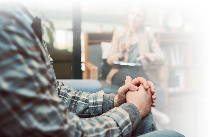 Photo close-up of a man's hands while seated and conversing with a female therapist. Photo close-up of a man's hands while seated and conversing with a female therapist.