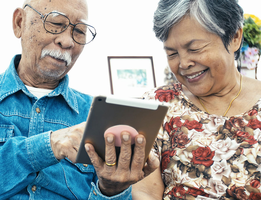 Photo of a senior couple with a digital tablet.