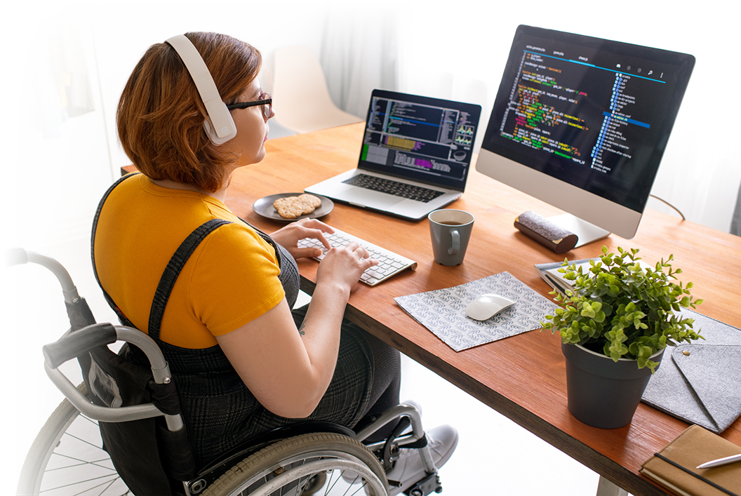 Young woman chair-user, at a desk performing computer coding.